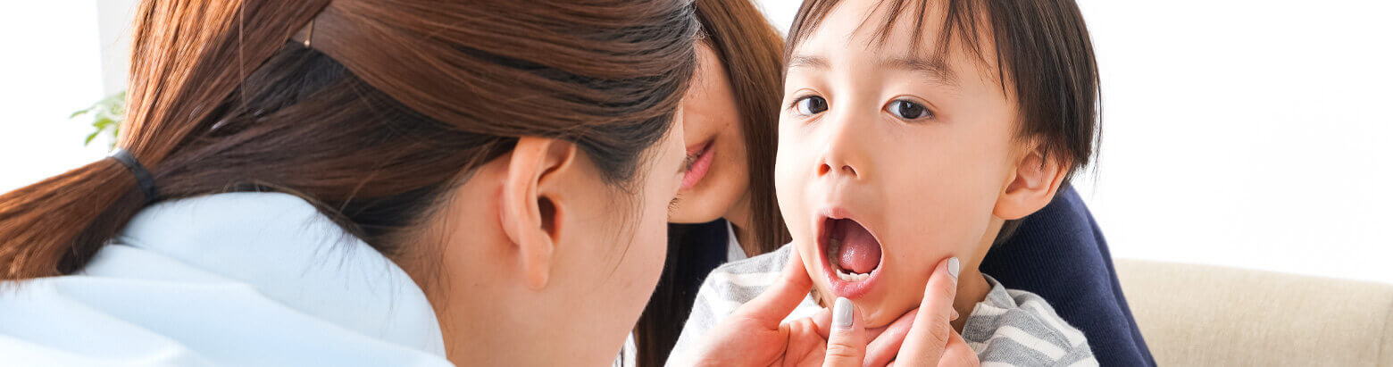 Doctor examining a childs mouth