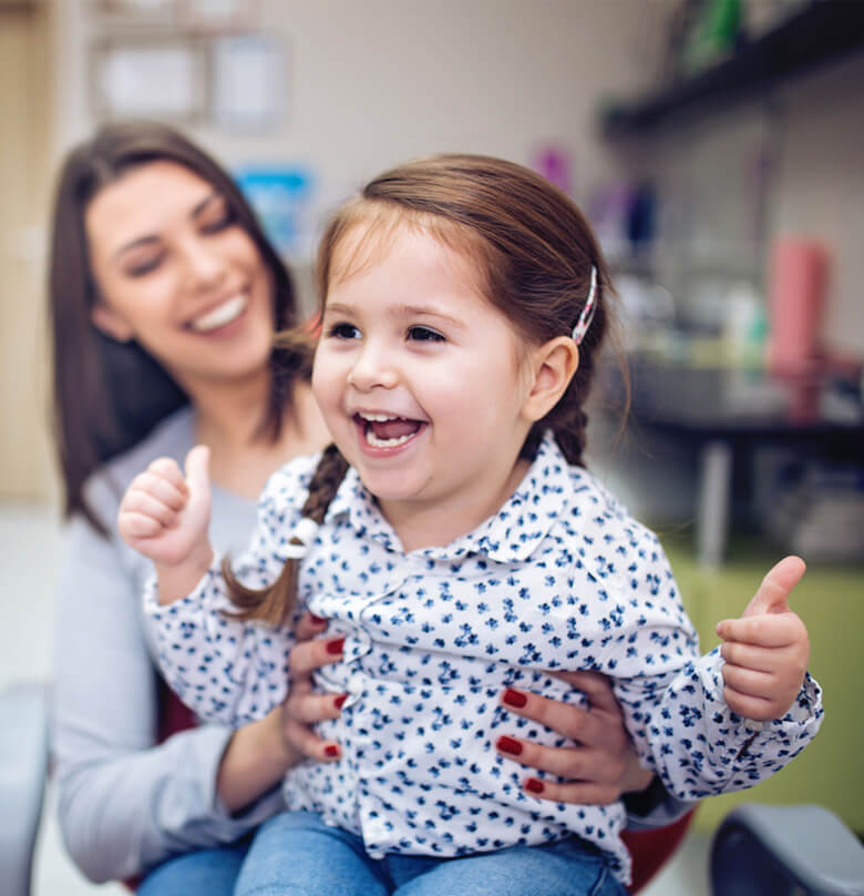 child playing on moms lap