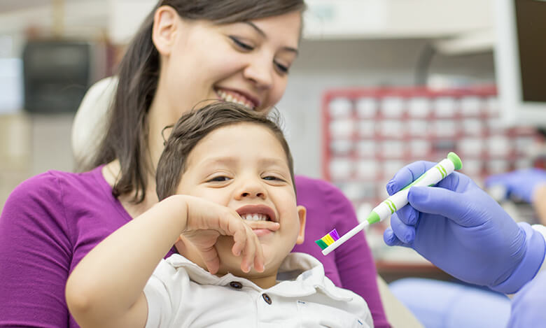 mother holding her son at the dentist's office