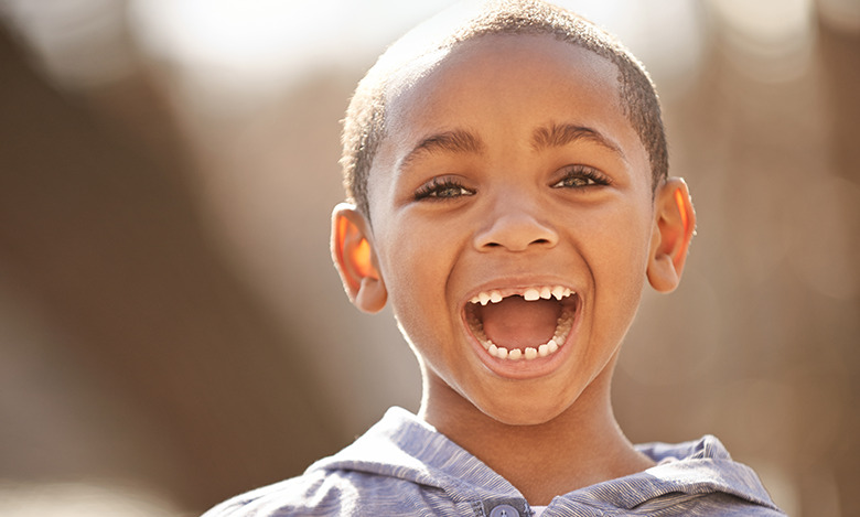 young boy smiling big